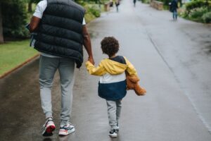 father walking with his son in a park