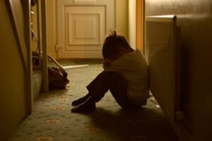 kid sitting in hallway